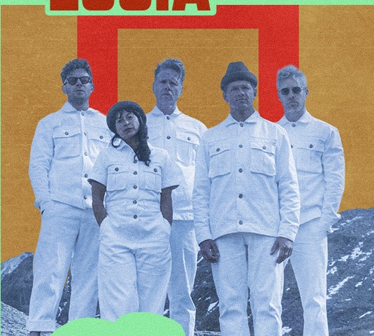 St. Lucia band members standing together in white outfits